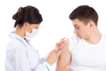 pharmacist vaccinating a young man