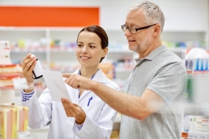 senior man assisted by a pharmacist